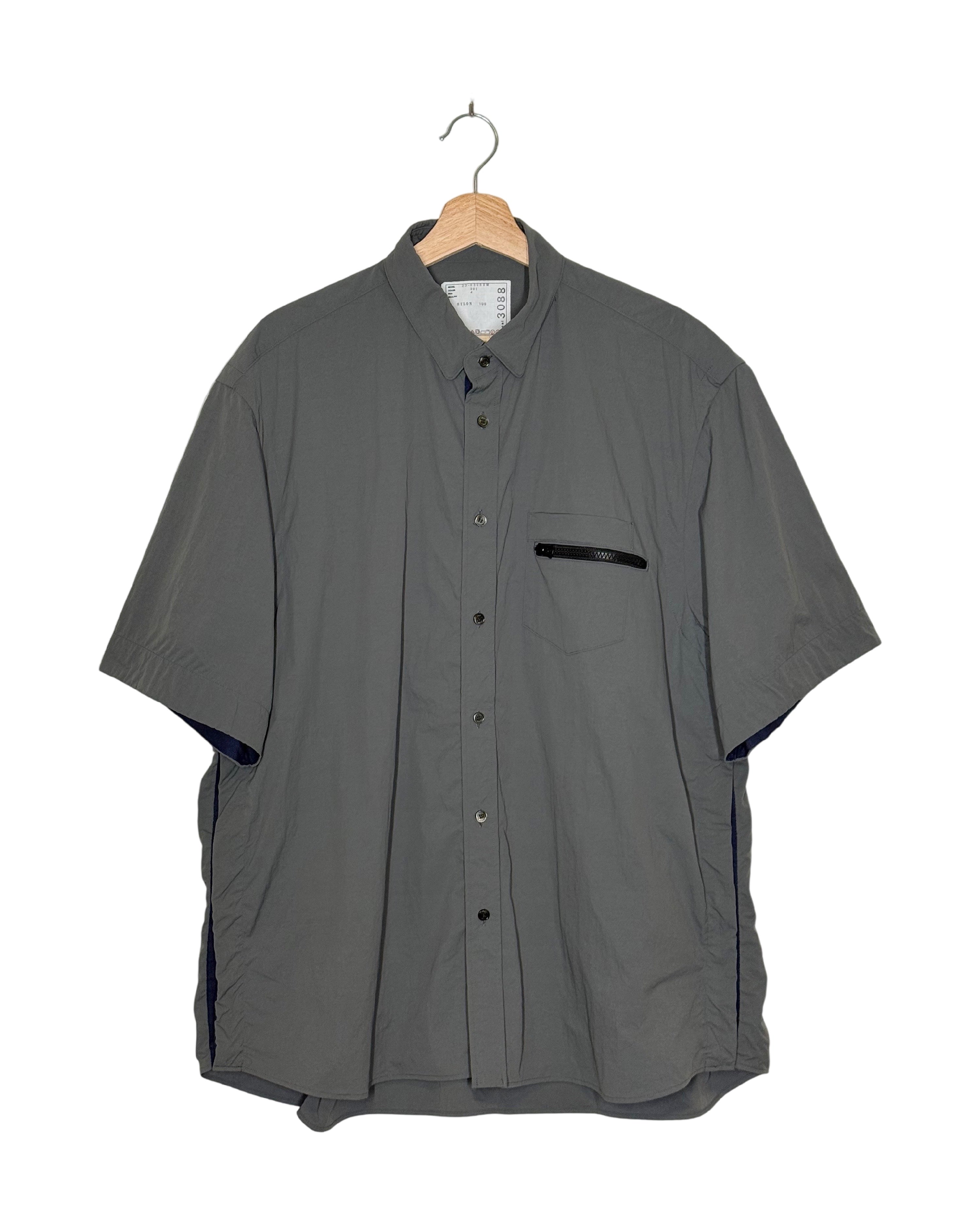 Sacai 2023SS tech short sleeve shirt - front view on hanger, short sleeve shirt in Sacai's technical fabric treatment