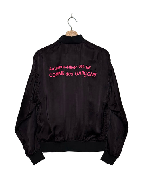 Comme des Garcons 2018SS Hankyu Umeda exclusive cupro staff blouson - front view on hanger, fluid magenta cupro with AW84-85 store-exclusive graphic